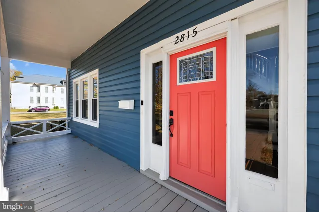 a view of a bedroom with wooden floor and windows