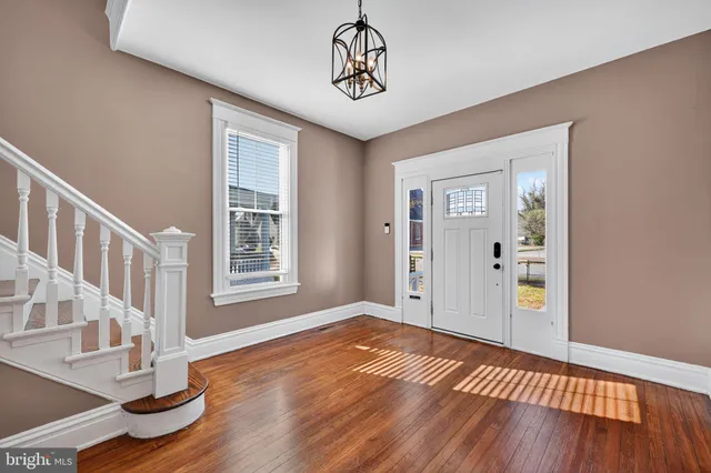 a view of an entryway with wooden floor