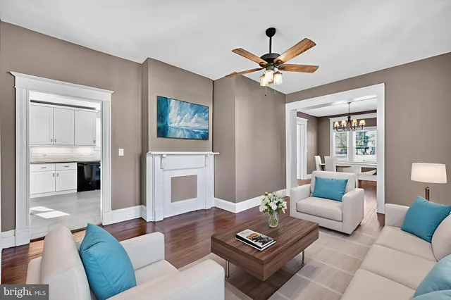 a living room with furniture a rug and a fireplace