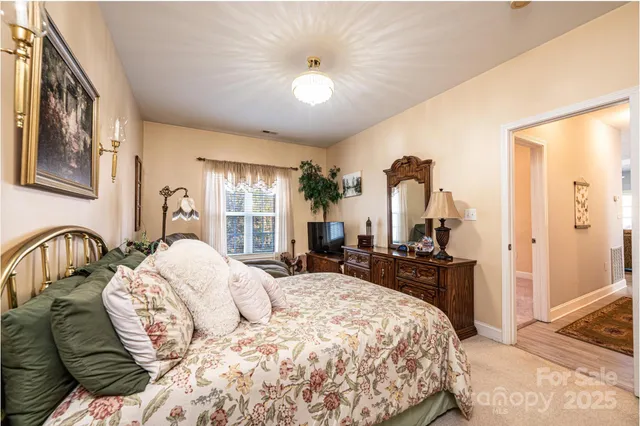 a bedroom with a bed and dresser with mirror