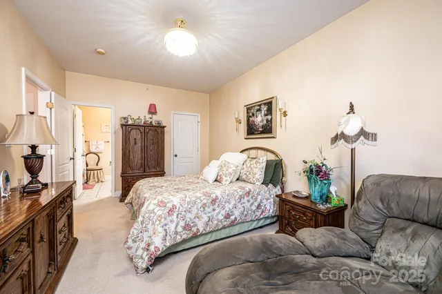 a bedroom with bed and a chandelier