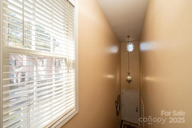 a bedroom with a bed and a chandelier fan