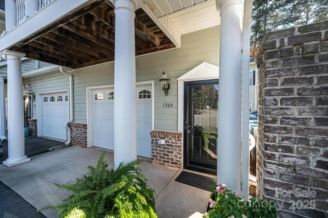 a backyard of a house with outdoor seating and plants