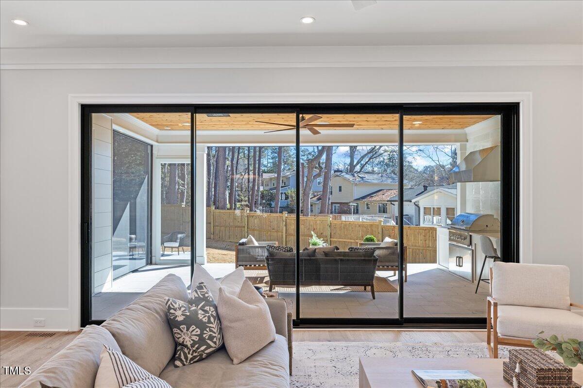 4906 Tremont Drive Raleigh, NC 27609 - Photo 12 of 71 a living room with couch and a floor to ceiling window