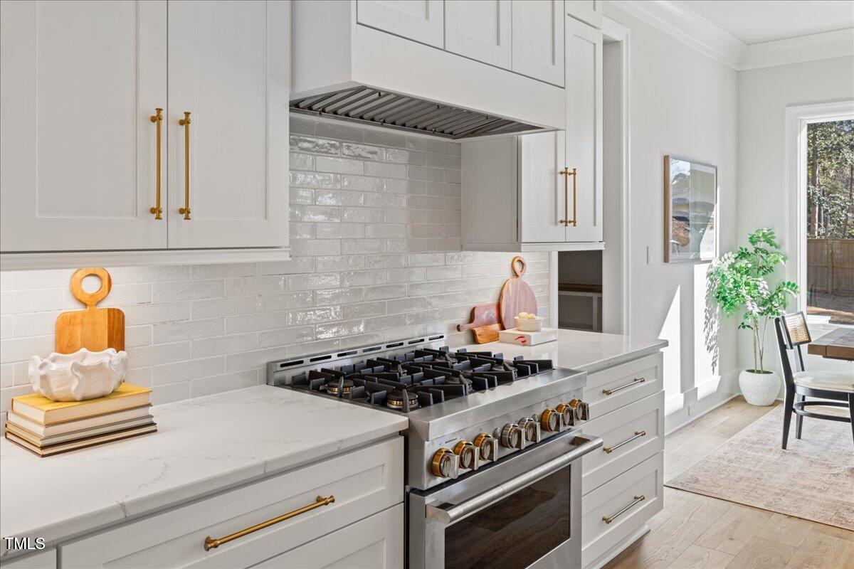 4906 Tremont Drive Raleigh, NC 27609 - Photo 17 of 71 a kitchen with stainless steel appliances granite countertop a stove and a cabinets