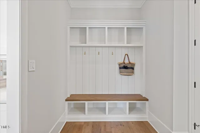 a bedroom with a bed chandelier and a window