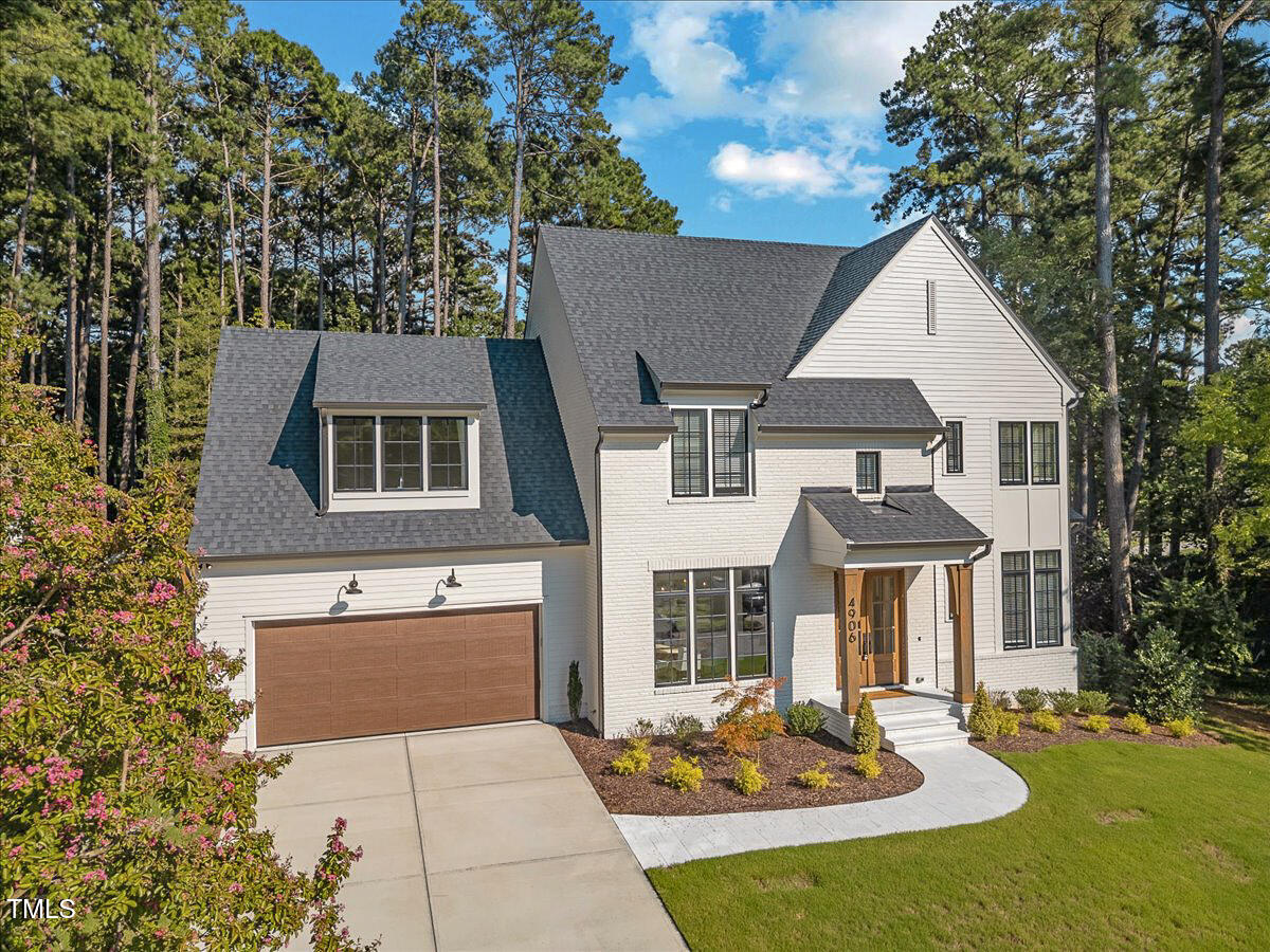 4906 Tremont Drive Raleigh, NC 27609 - Photo 3 of 71 a front view of a house with a yard table and chairs