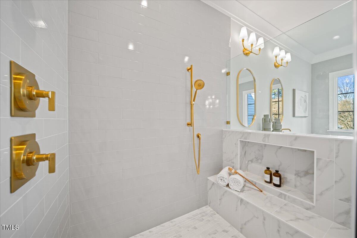 4906 Tremont Drive Raleigh, NC 27609 - Photo 31 of 71 a bathroom with a sink a toilet and a mirror