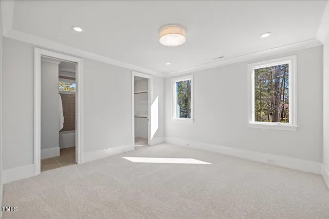 a spacious bathroom with a mirror sink and shower