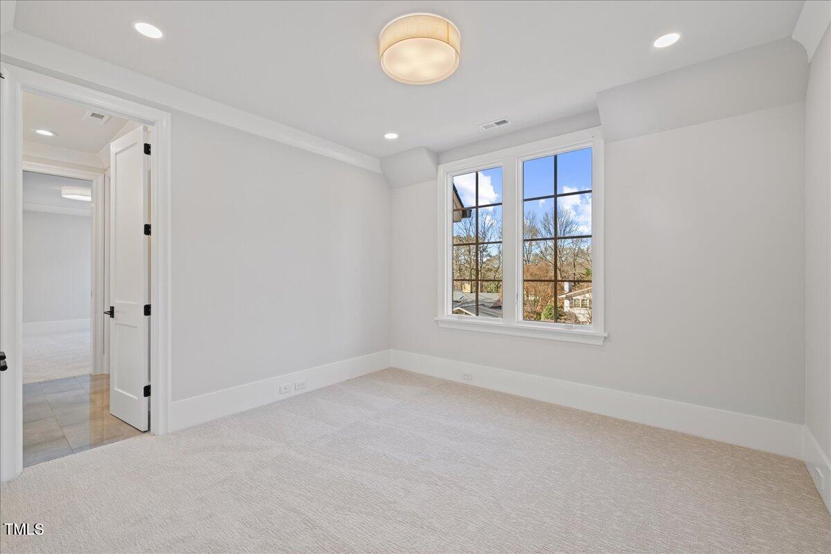 4906 Tremont Drive Raleigh, NC 27609 - Photo 42 of 71 a view of an empty room with a window