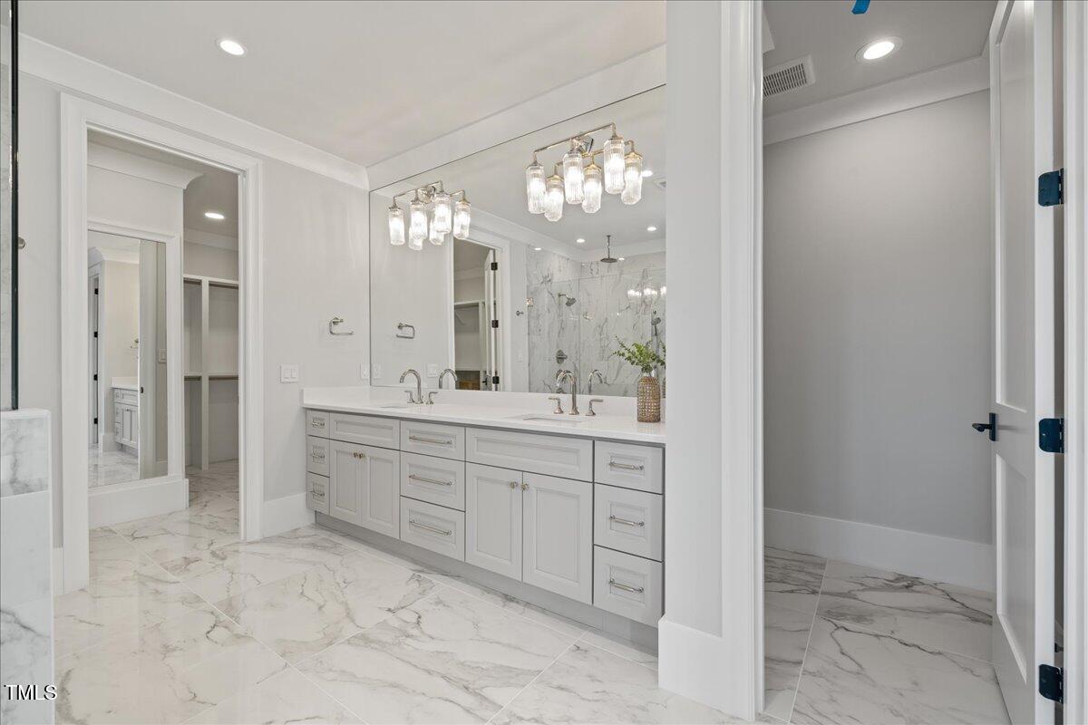 4906 Tremont Drive Raleigh, NC 27609 - Photo 48 of 71 a spacious bathroom with a mirror sink and shower
