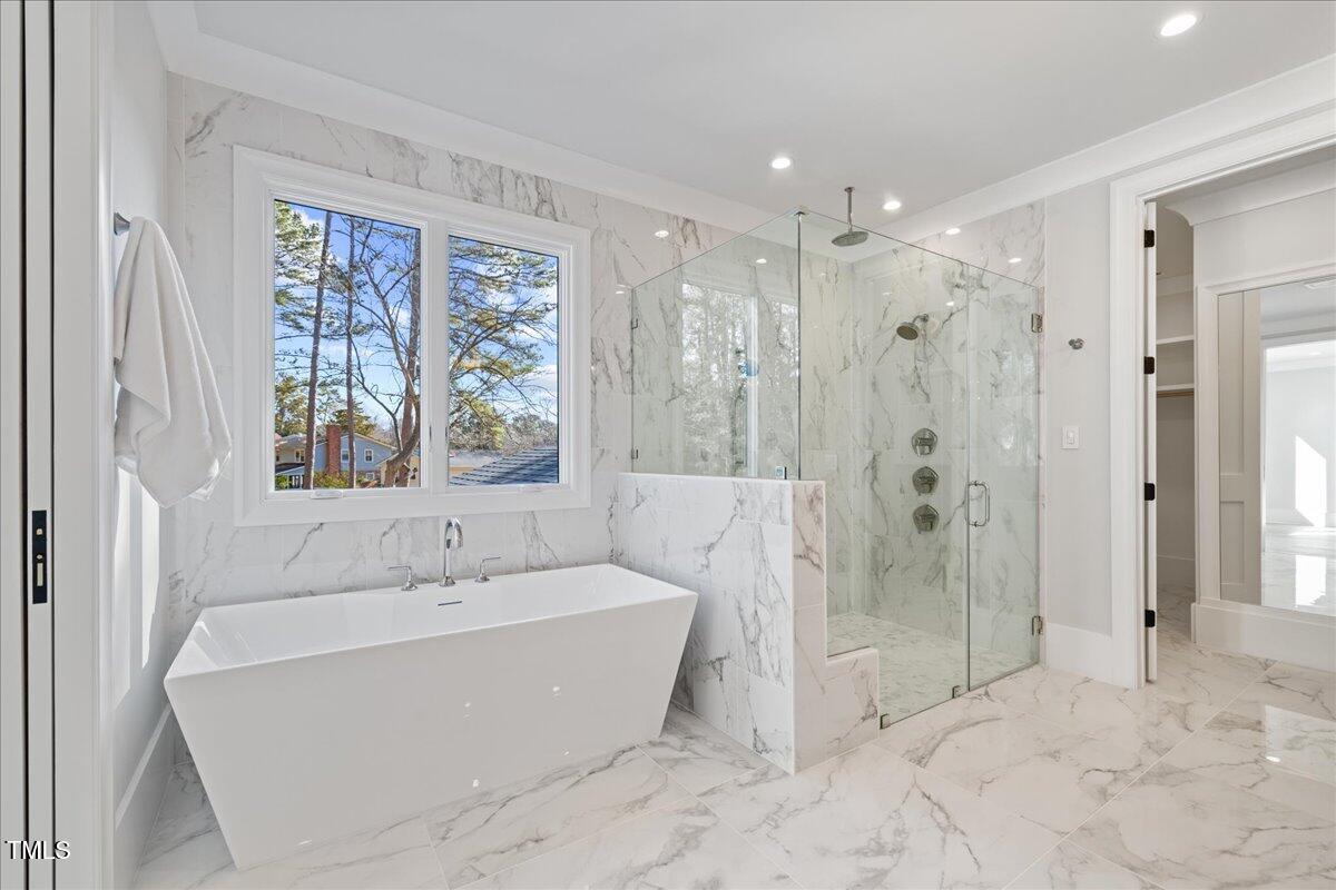 4906 Tremont Drive Raleigh, NC 27609 - Photo 49 of 71 a bathroom with a bathtub and a shower