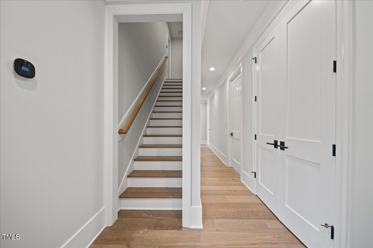 4906 Tremont Drive Raleigh, NC 27609 - Photo 57 of 71 a view of a hallway with wooden floor and entryway