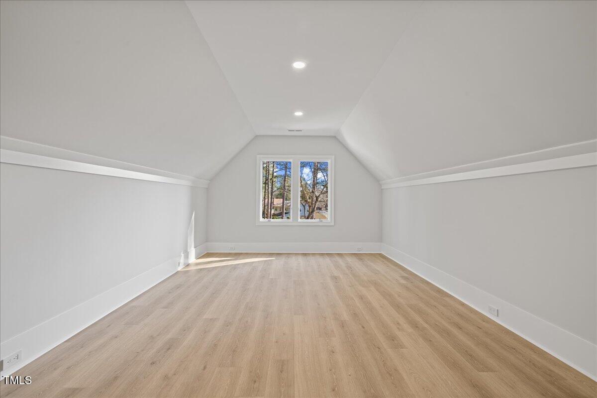 4906 Tremont Drive Raleigh, NC 27609 - Photo 60 of 71 an empty room with wooden floor and windows
