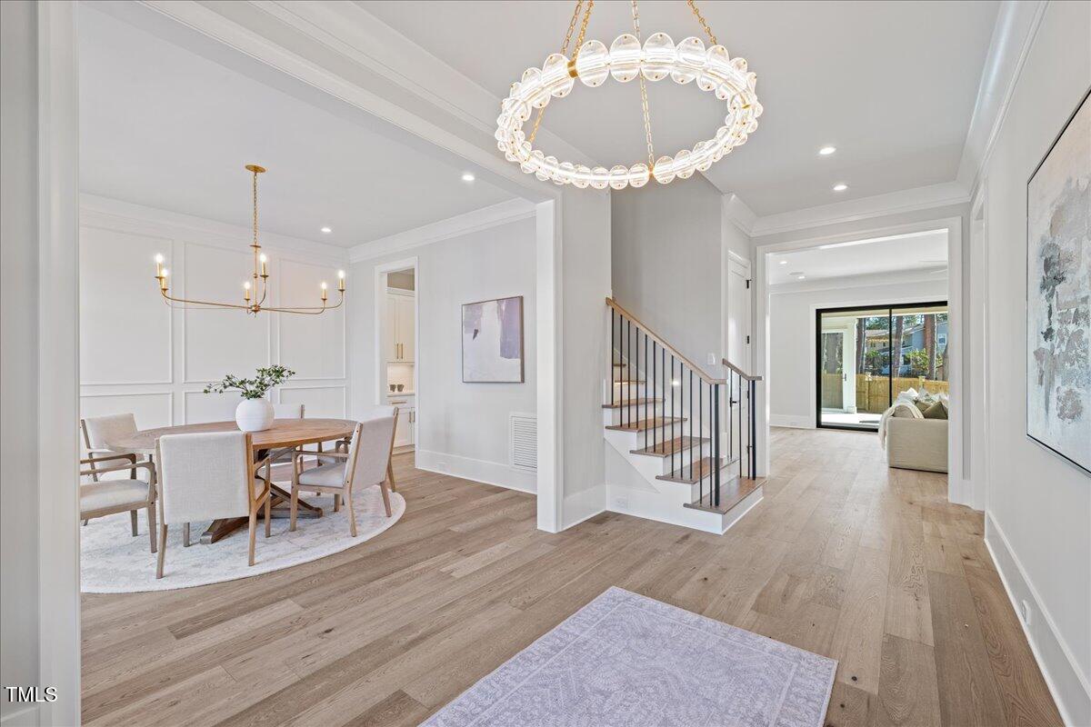 4906 Tremont Drive Raleigh, NC 27609 - Photo 6 of 71 a view of a dining room with furniture and wooden floor