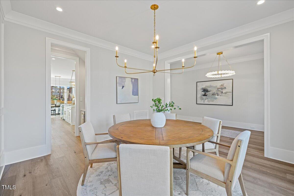 4906 Tremont Drive Raleigh, NC 27609 - Photo 8 of 71 a view of a dining room with furniture and wooden floor