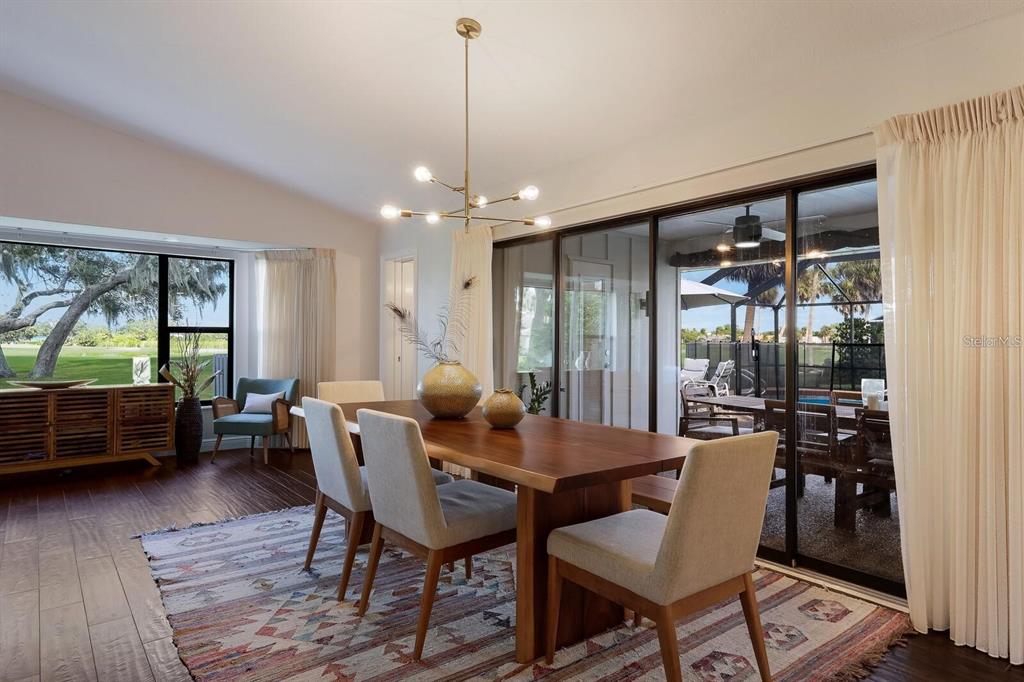3705 Torrey Pines Boulevard Sarasota, FL 34238 - Photo 12 of 30 a view of a dining room with furniture window and wooden floor