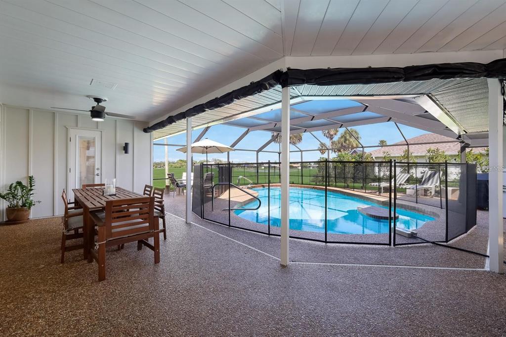 3705 Torrey Pines Boulevard Sarasota, FL 34238 - Photo 13 of 30 a view of a roof deck with a table and chairs under an umbrella