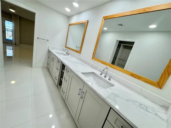 a view of a kitchen with a sink refrigerator and a large window