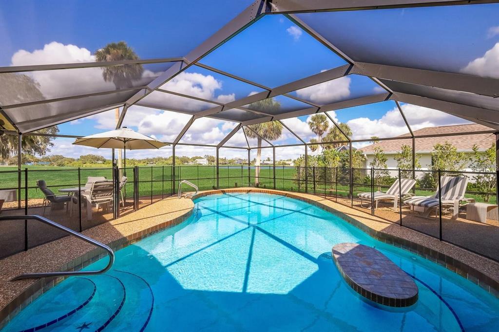 3705 Torrey Pines Boulevard Sarasota, FL 34238 - Photo 14 of 30 a view of a swimming pool with a lounge chairs