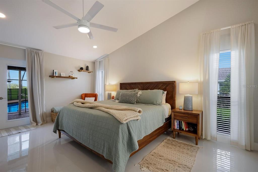 3705 Torrey Pines Boulevard Sarasota, FL 34238 - Photo 16 of 30 a bedroom with a bed and a chandelier