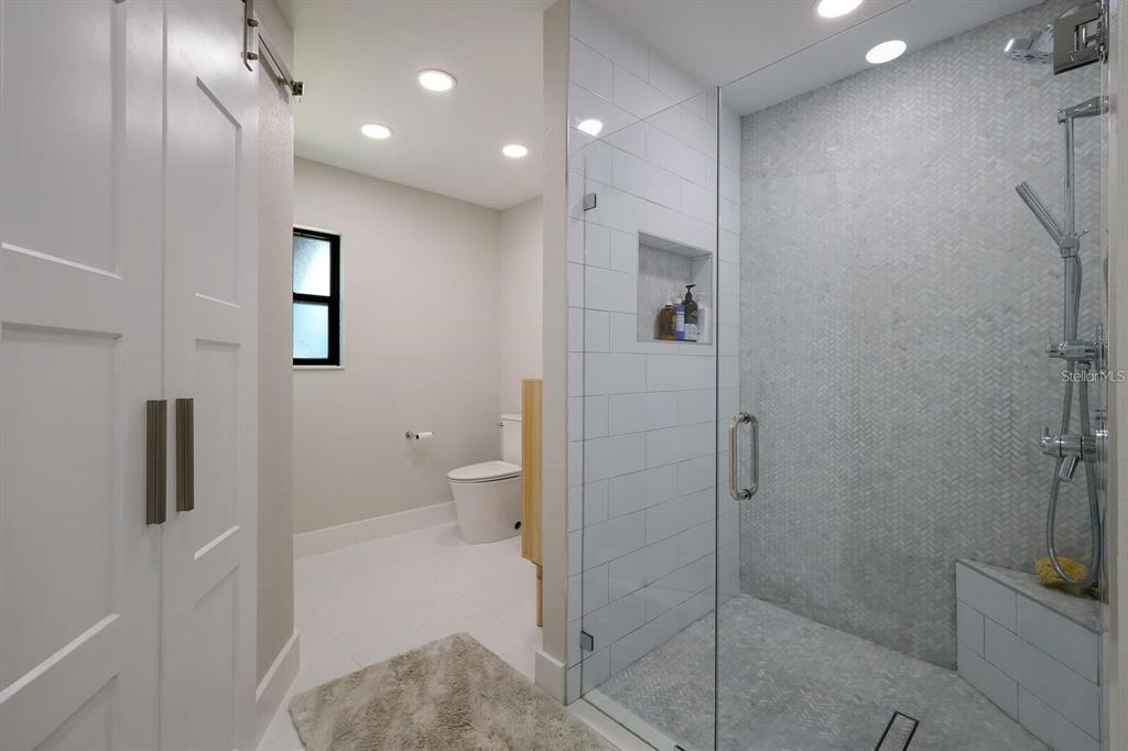 3705 Torrey Pines Boulevard Sarasota, FL 34238 - Photo 19 of 30 a bathroom with a shower and a toilet