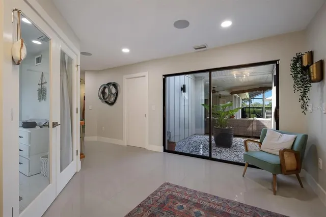 a living room with furniture and a glass door shower