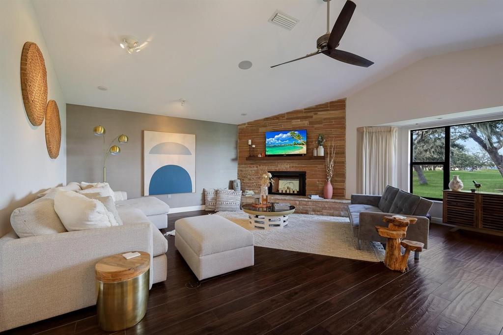 3705 Torrey Pines Boulevard Sarasota, FL 34238 - Photo 6 of 30 a living room with furniture and a fireplace