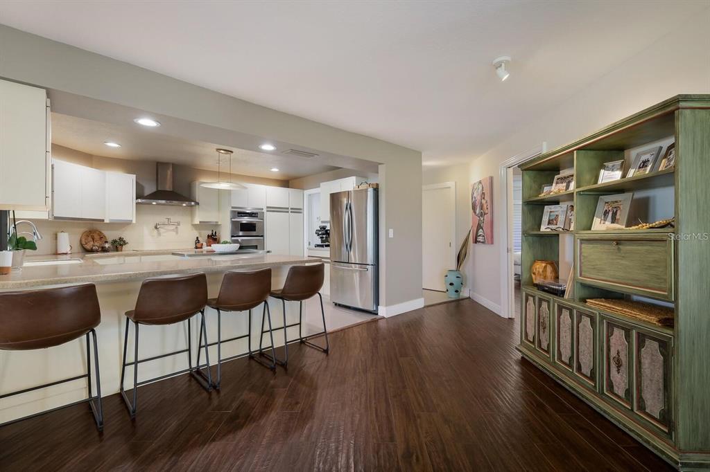 3705 Torrey Pines Boulevard Sarasota, FL 34238 - Photo 8 of 30 a kitchen with stainless steel appliances granite countertop a refrigerator and a stove top oven