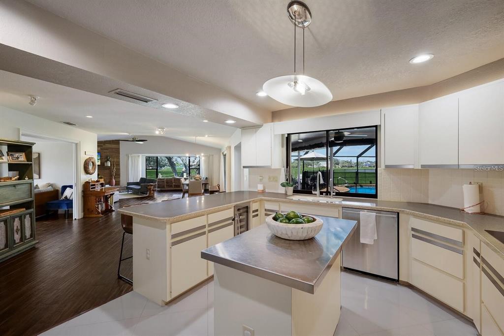 3705 Torrey Pines Boulevard Sarasota, FL 34238 - Photo 10 of 30 a kitchen with a stove a refrigerator and a view of living room