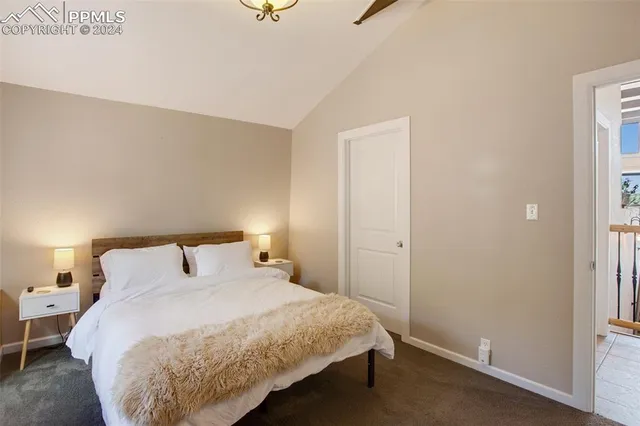 a bedroom with a bed and a night stand