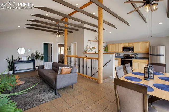 a living room with furniture and kitchen view