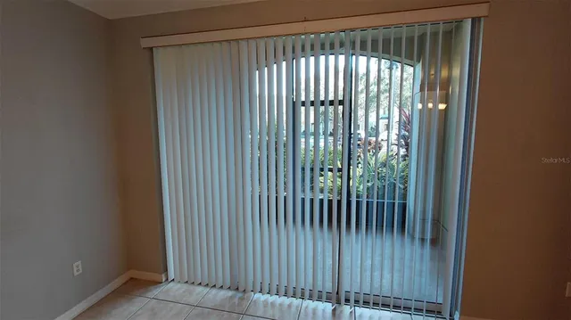a view of a room that has a window and a ceiling fan