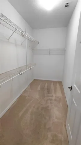 a view of a hallway to rooms