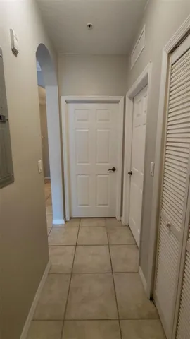 an empty room with a fan and a ceiling fan