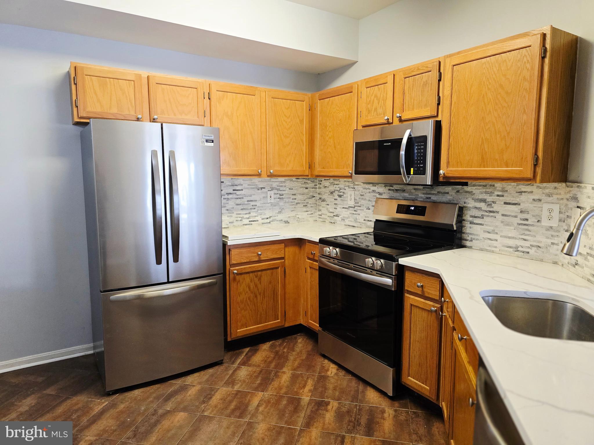 1683 Fallowfield Court Crofton, MD 21114 - Photo 2 of 28 a kitchen with stainless steel appliances granite countertop a refrigerator and a sink