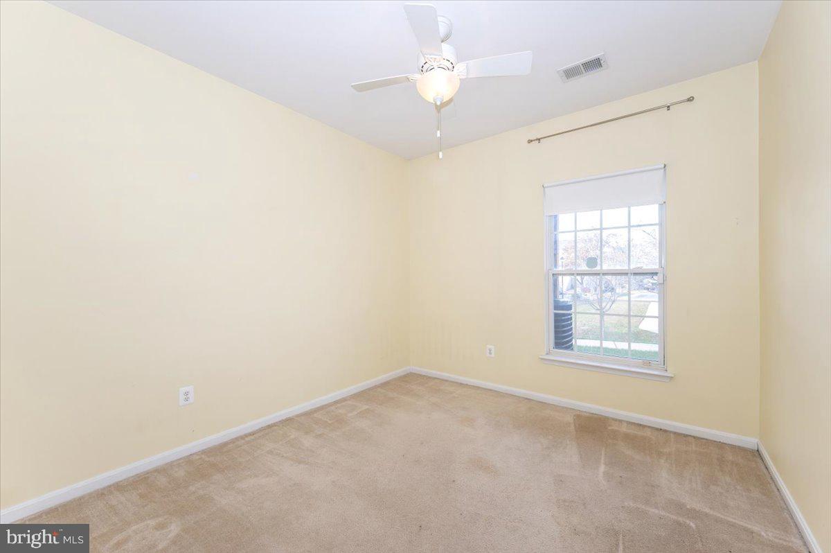 1683 Fallowfield Court Crofton, MD 21114 - Photo 21 of 28 an empty room with a window and a ceiling fan