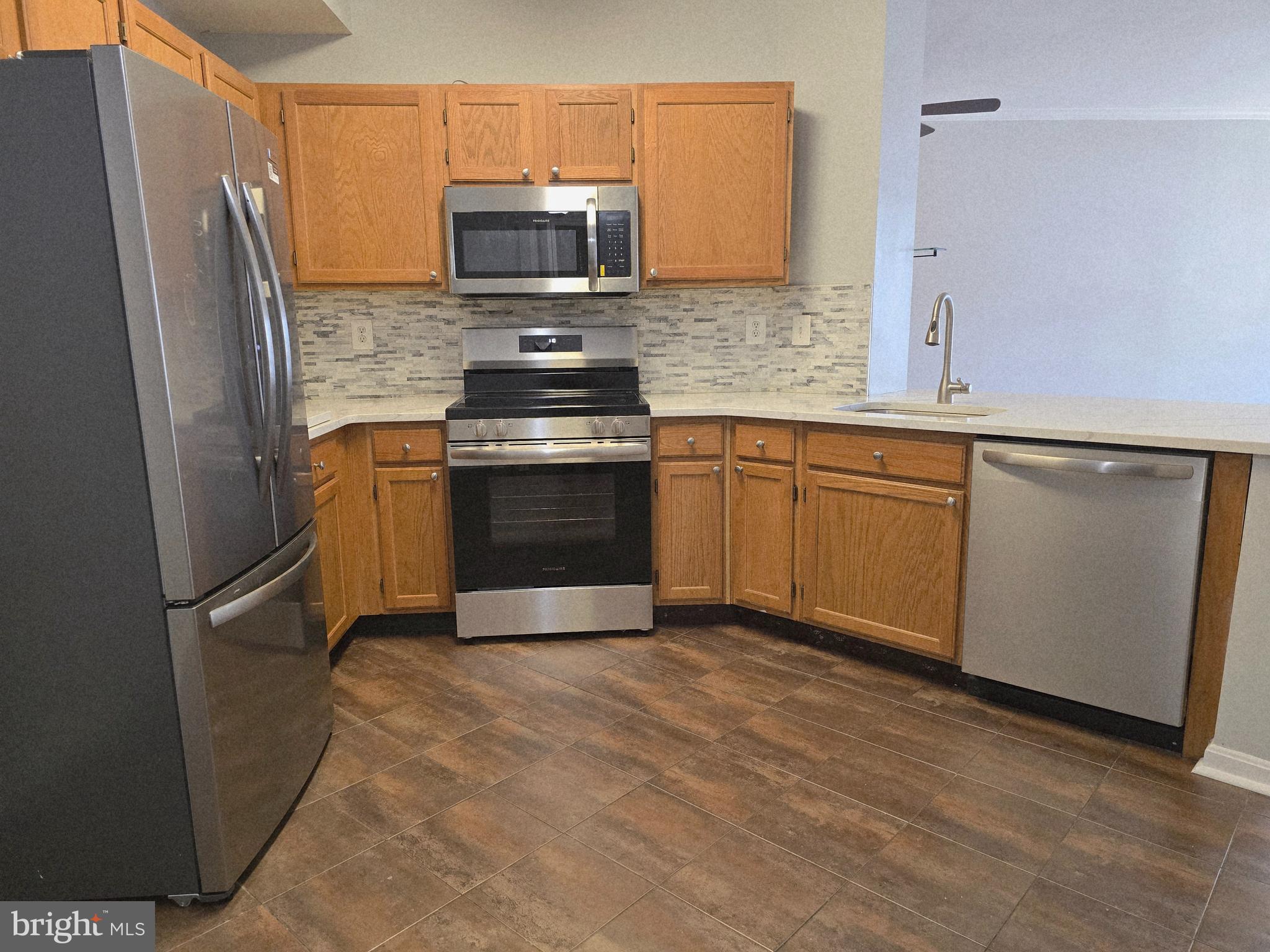 1683 Fallowfield Court Crofton, MD 21114 - Photo 3 of 28 a kitchen with stainless steel appliances granite countertop a refrigerator stove top oven a sink and dishwasher