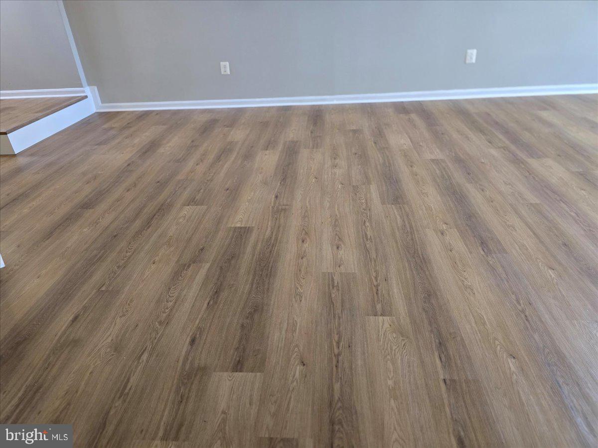 1683 Fallowfield Court Crofton, MD 21114 - Photo 9 of 28 a view of an empty room with wooden floor