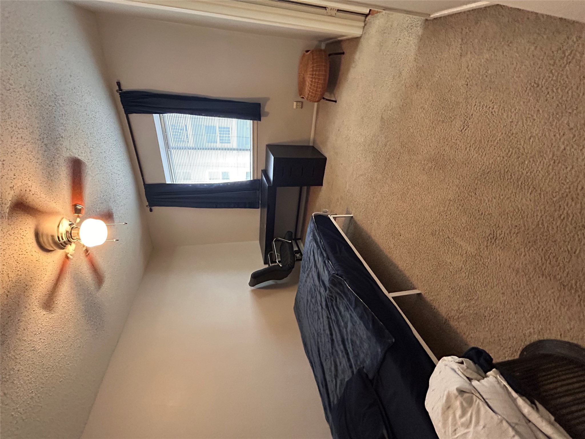 3115 Helms Street, Unit 109 Austin, TX 78705 - Photo 6 of 9 Carpeted bedroom featuring a textured ceiling and ceiling fan