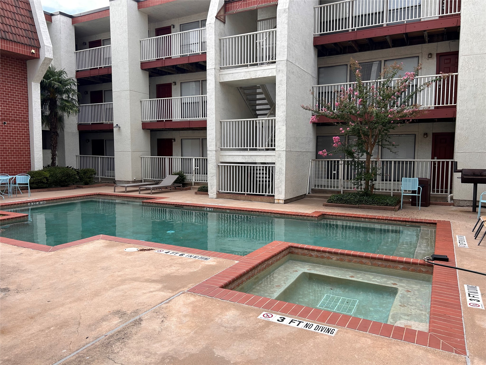 3115 Helms Street, Unit 109 Austin, TX 78705 - Photo 8 of 9 Community pool featuring a community hot tub