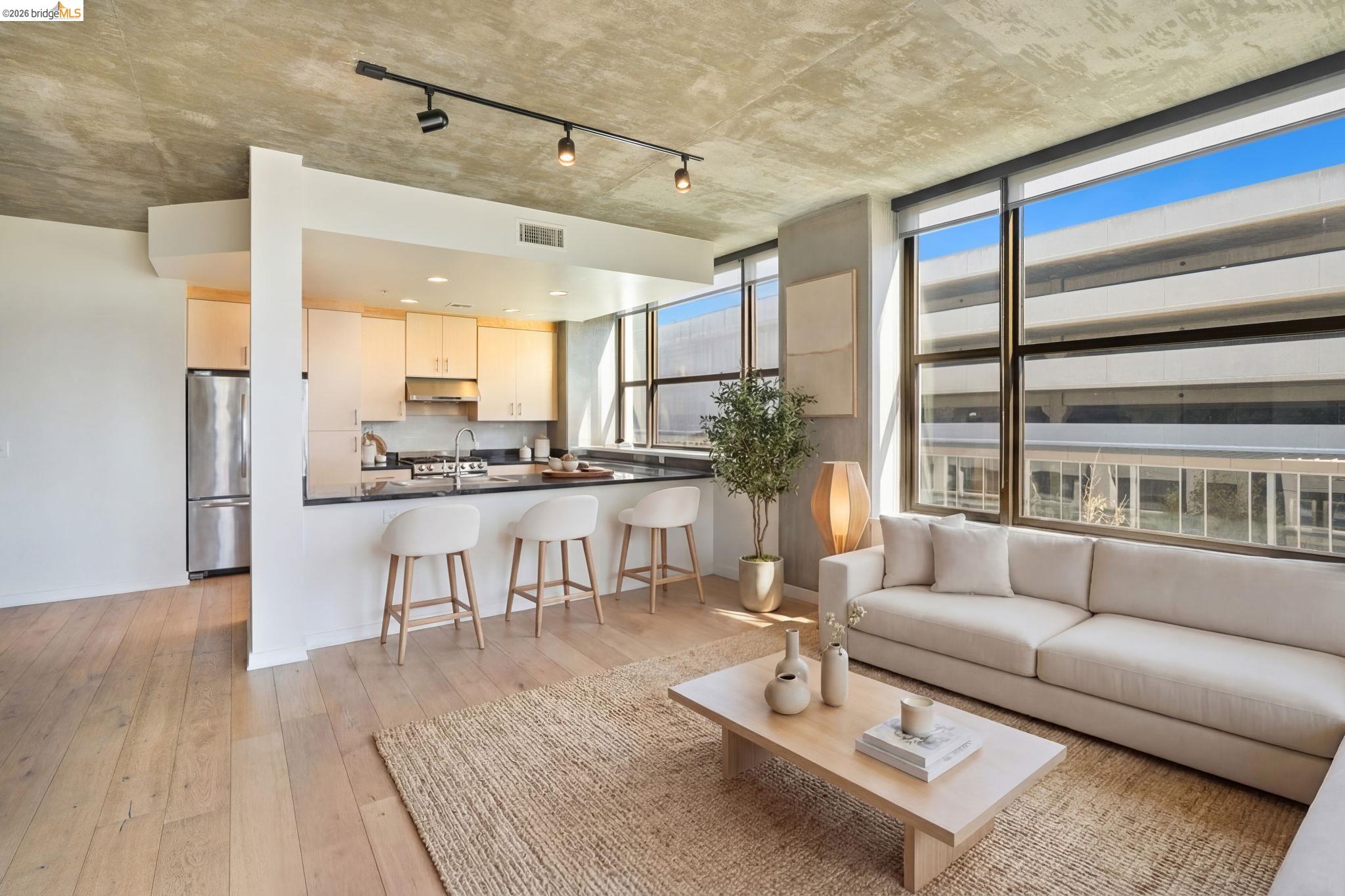 311 2nd Street, Unit 511 Oakland, CA 94607 - Photo 18 of 44 Living room featuring rail lighting and light wood-style floors