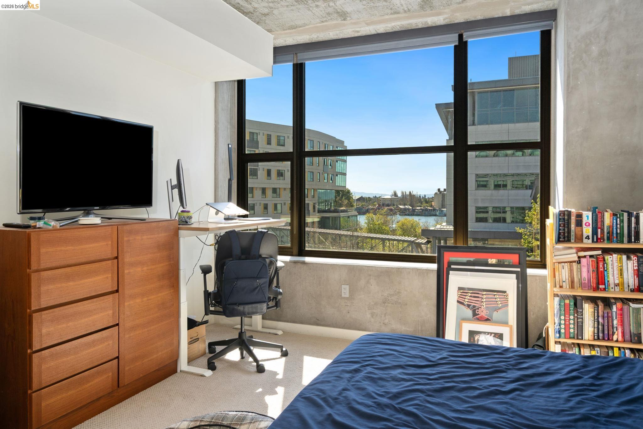 311 2nd Street, Unit 511 Oakland, CA 94607 - Photo 26 of 44 Bedroom featuring a desk, carpet flooring, multiple windows, and a city view