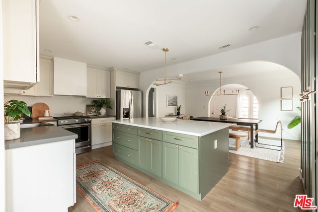 a kitchen with a sink stove and wooden cabinets