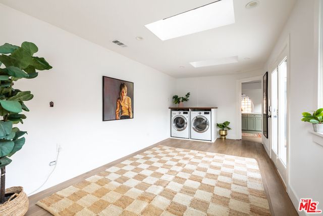 a spacious bedroom with a bed and a potted plant