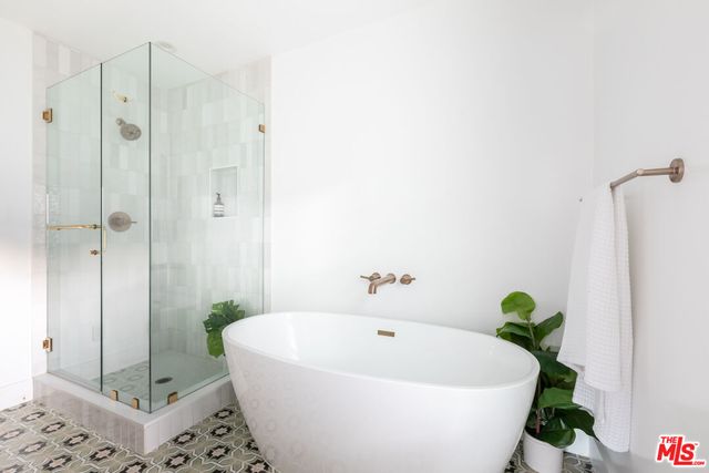 a white bath tub sitting next to a shower