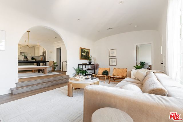 a living room with furniture and a mirror