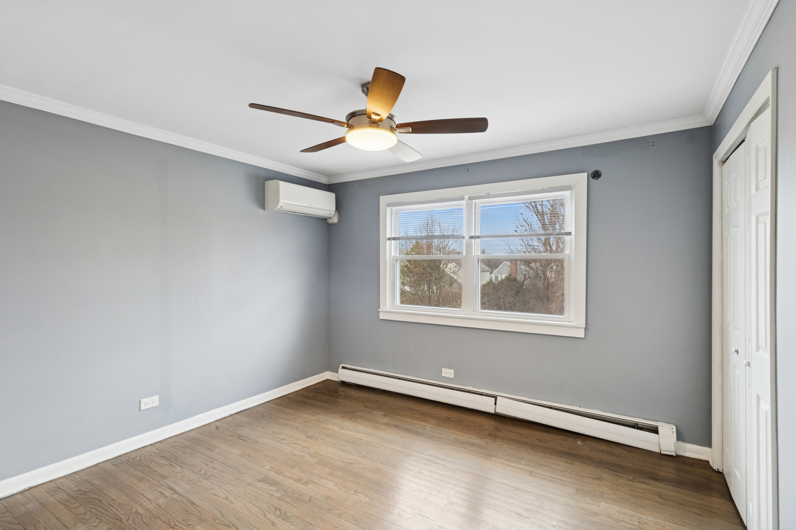 902 East Main Street Barrington, IL 60010 - Photo 15 of 33 an empty room with a window and a ceiling fan