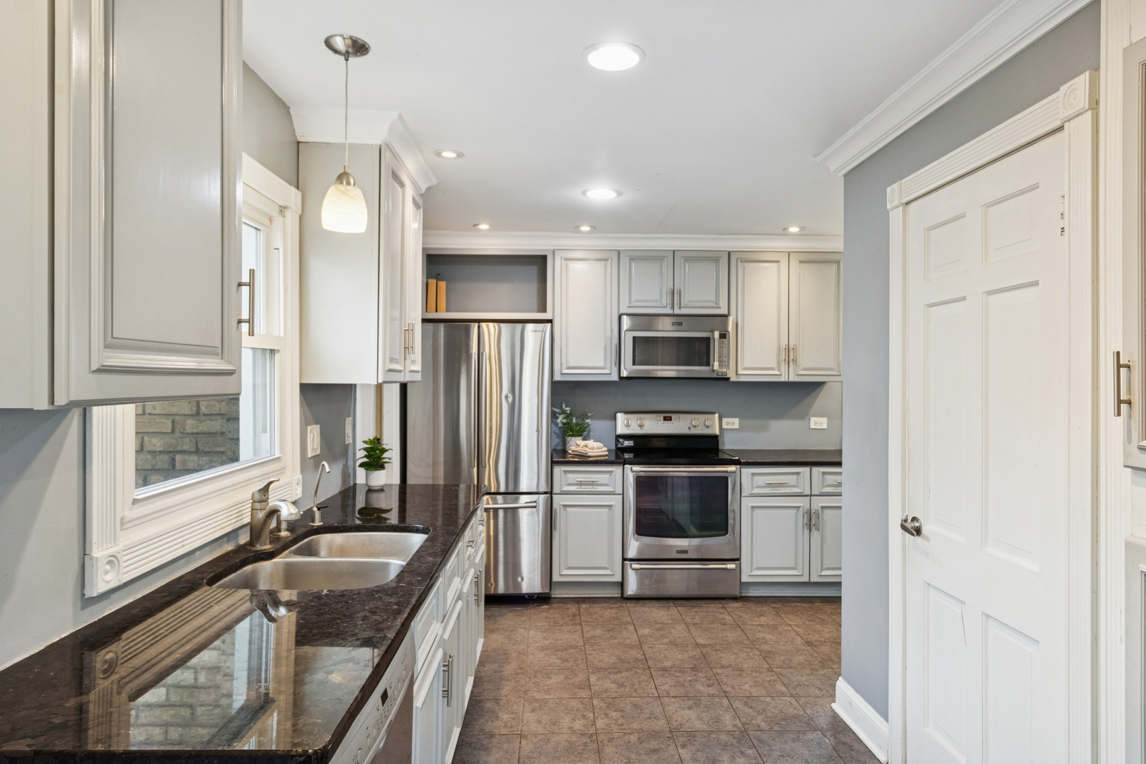 902 East Main Street Barrington, IL 60010 - Photo 5 of 33 a kitchen with stainless steel appliances granite countertop a sink stove and refrigerator