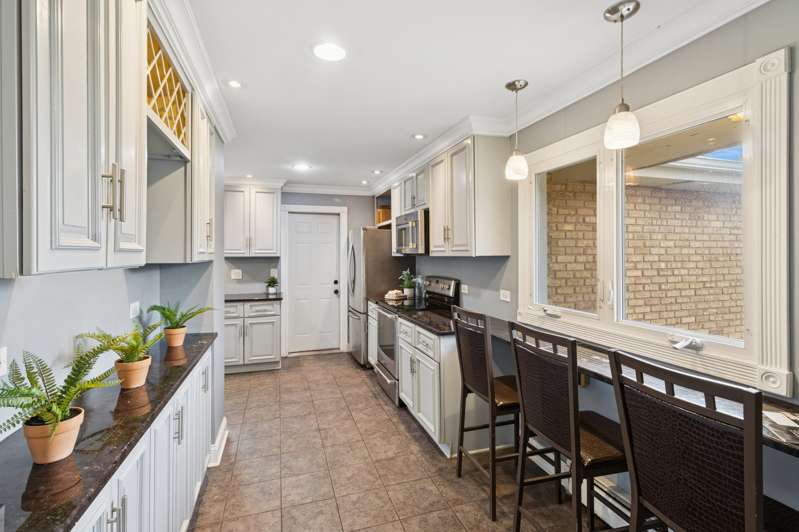 902 East Main Street Barrington, IL 60010 - Photo 6 of 33 a kitchen with stainless steel appliances kitchen island granite countertop a stove a sink and a refrigerator